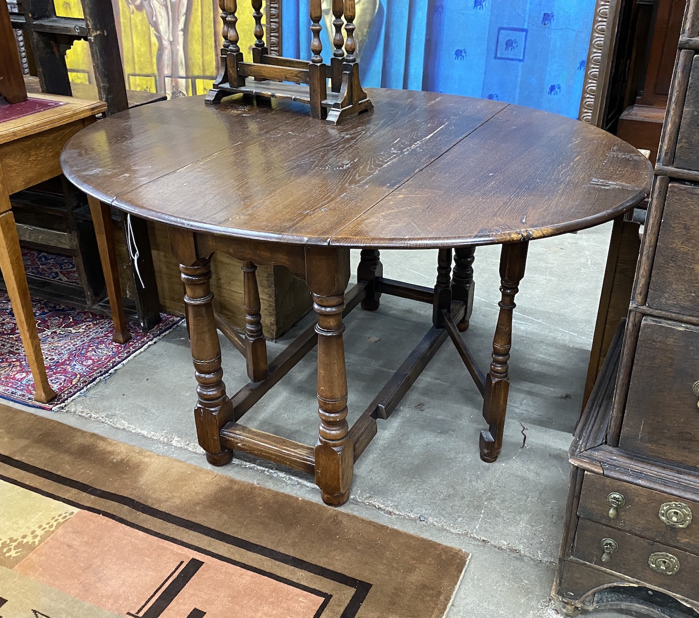 An 18th century style oak gateleg dining table, 140cm extended, depth 120cm, height 73cm